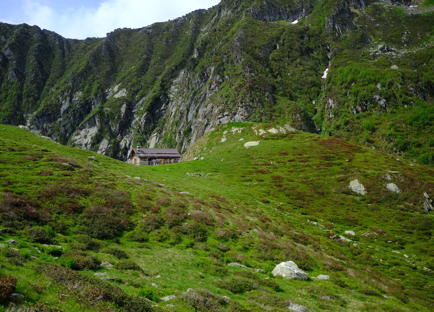 Il rifugio Alpe Selle circondato dai verdi prati alpini adibiti a pascolo.